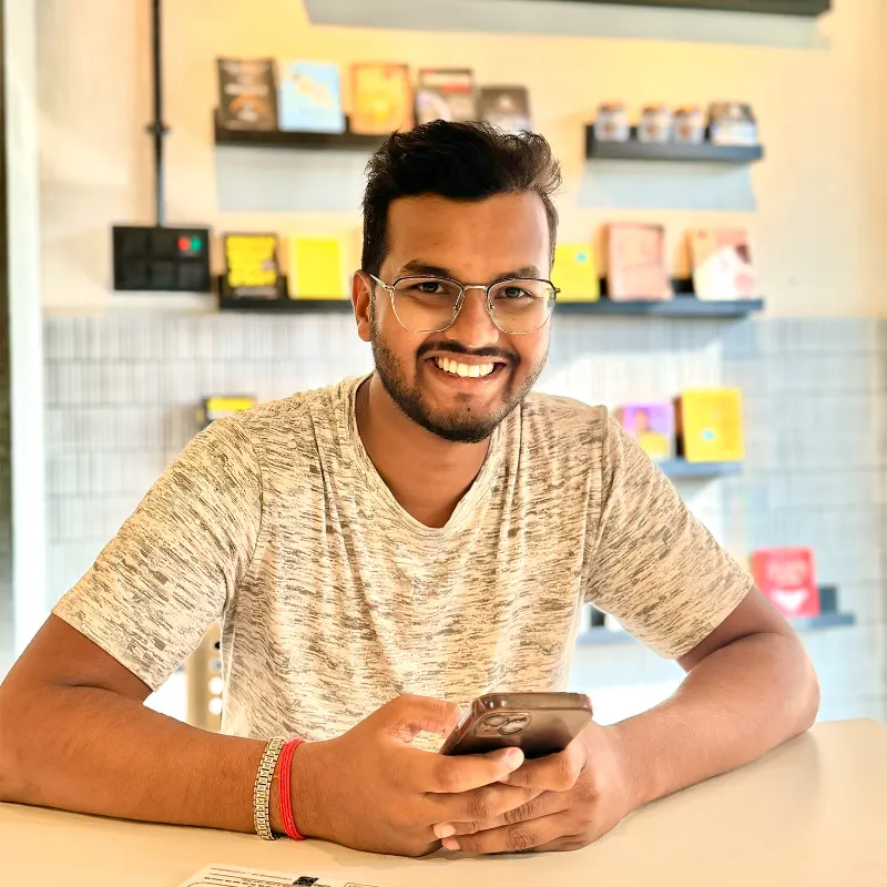 Portrait of Anand Verma smiling at a café table